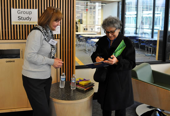 Arlene Alda signing copy of her book 