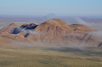 Views of mountains, dunes and the fog.