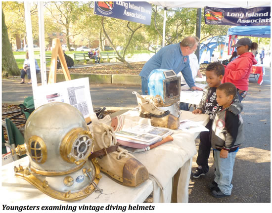 Youngsters examining vintage diving helmets 